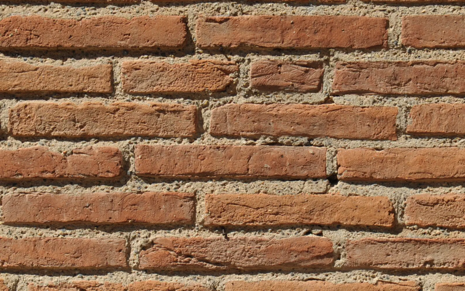 Close up of brickwork with sand and cement mortar joints