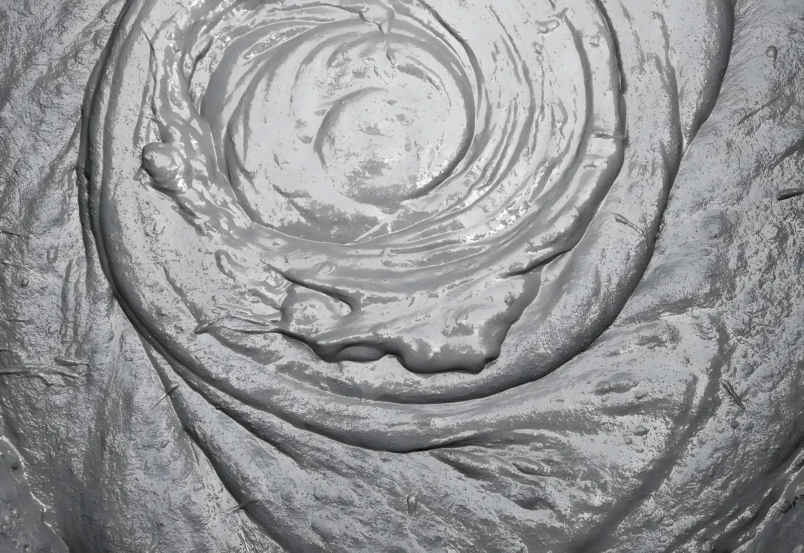 Swirl of freshly mixed grey concrete